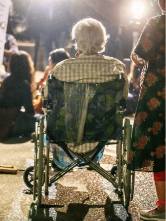A wheelchair-bound Zafrullah Chowdhury joins a protest rally against rape.