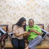 A daughter sitting with her father.