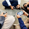 A bunch of young kids playing games on their smartphones. A bunch of young kids playing games on their smartphones.