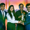 The winners being awarded the trophy