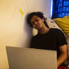 A boy falling asleep while trying to work. A boy falling asleep while trying to work.