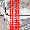 Smeared out print of a tyre against a backdrop of a wrecked vehicle