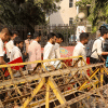 HSC examinees walking to the exam centre through police barricades set up due to political unrest HSC examinees walking to the exam centre through police barricades set up due to political unrest