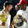 Serbia's Novak Djokovic poses with the trophy after winning the Wimbledon men's singles final alongside runner up Australia's Nick Kyrgios, July 2022.