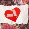 A broken heart on a tattered piece of paper against a vivid background.