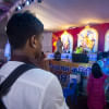A student wearing his school's uniform while praying.