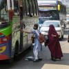 Student getting on a bus.