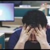 Person with their hands on their head, visibly stressed.