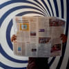 Person reading a newspaper.