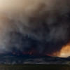 The McDougall Creek wildfire burns in the hills in West Kelowna, British Columbia, Canada, on August 17, 2023, as seen from Kelowna.