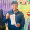 DU BCL president poses with ballot paper with vote for boat DU BCL President Poses with Boat Symbol on Ballot
