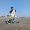 Surfer Younus Ali with his favourite surfing board at Shugondha Beach in front of Divine Eco Resort .