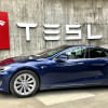 Tesla Tesla logo behind car