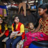 Red Crescent volunteers speaking to two children.