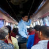 A student standing inside a bus.   A student standing inside a bus.