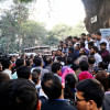 People huddled around group of protestors.  People huddled around group of protestors.