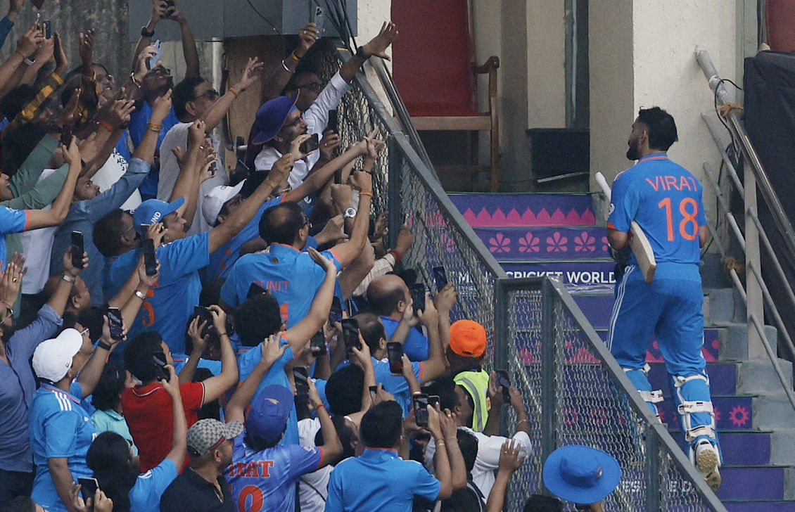 Virat Kohli walks off to the dressing amid rapturous applause after scoring a record 50th ODI century. Photo: Reuters