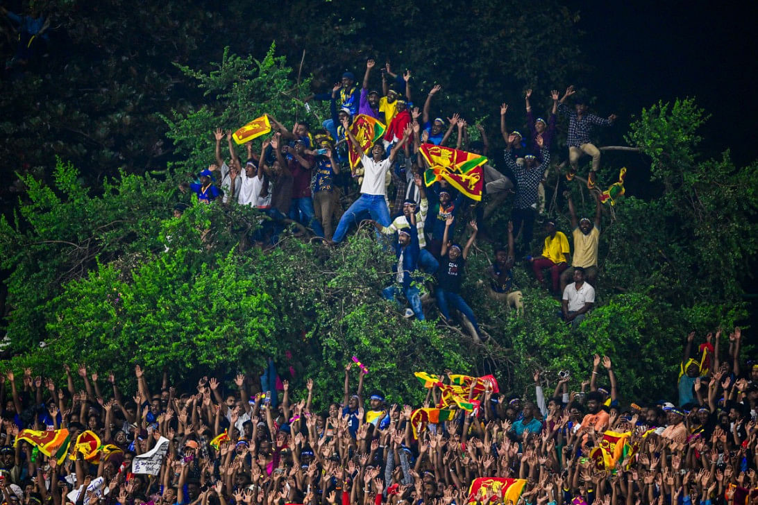 Spectators gather in various vantage points as they watch play during the second Twenty20 international cricket match between Afghanistan and Sri Lanka at the Rangiri Dambulla International Cricket Stadium in Dambulla on February 19, 2024. Photo: AFP