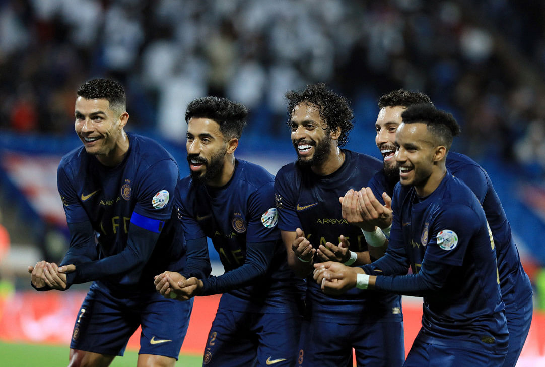 Al Nassr's Abdulmajeed Al-Sulaiheem (2L) celebrates scoring their fifth goal with Cristiano Ronaldo and teammates. Photo: Reuters