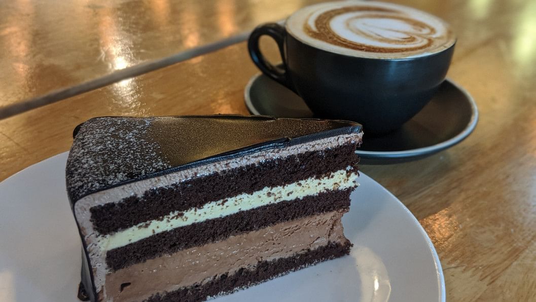 Top 5 coffee and cake shops in Dhaka. A slice of cake with a warm cup of coffee.