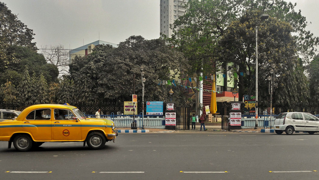 The streets of Kolkata showing a yellow taxi cab