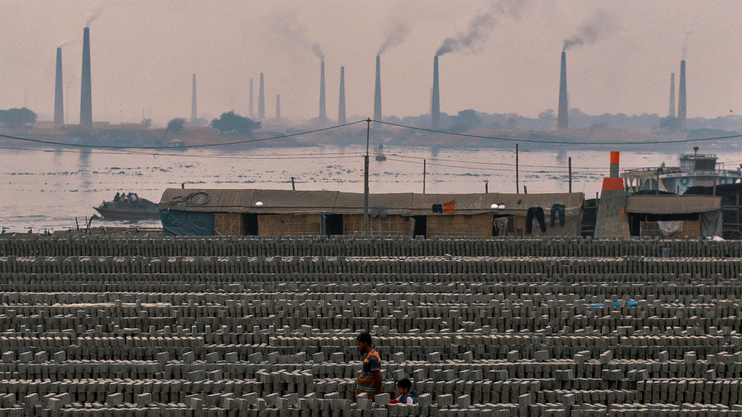 Rows of concrete with brick factories seen in the distance.