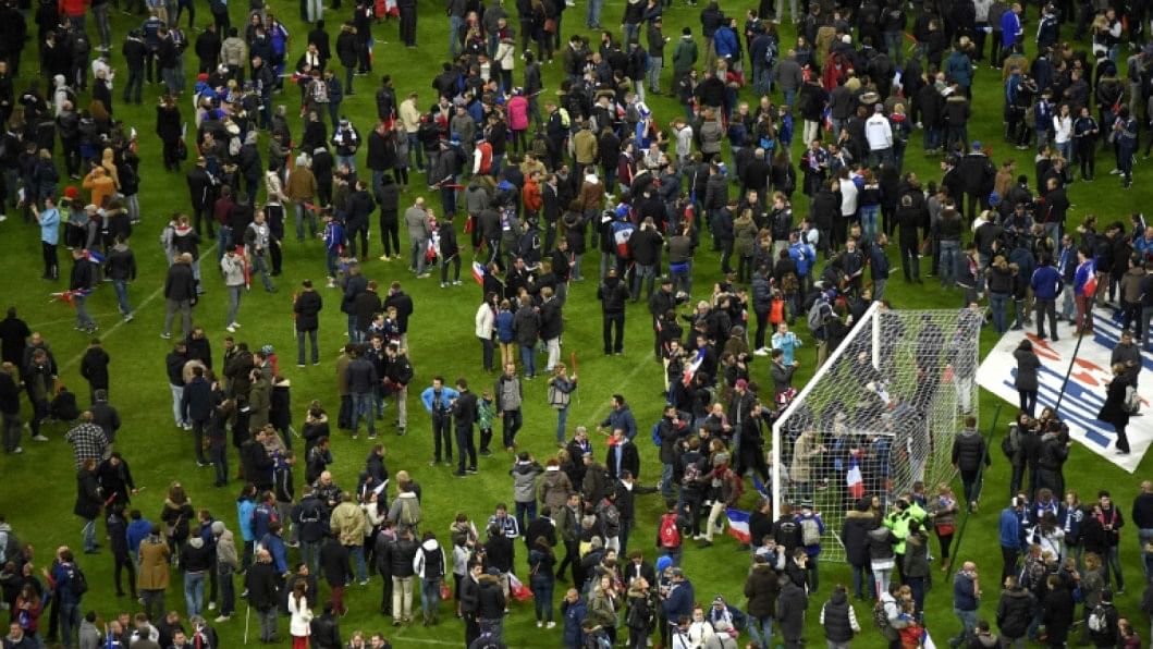 Football fans gather in the field after the attacks