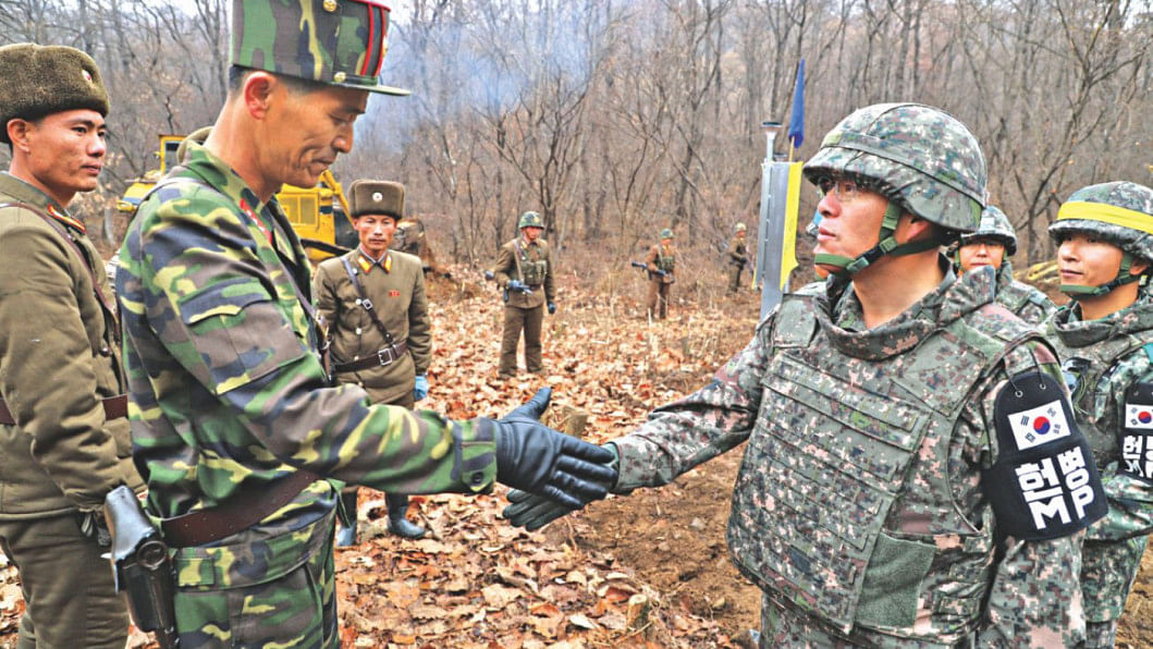 Two Korea shake hands | The Daily Star