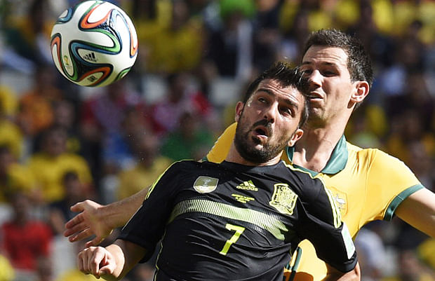 Spain's forward David Villa (Foreground) in action against Australia's defender Ryan McGowan during a Group B match between Australia and Spain at the Baixada Arena in Curitiba during the 2014 FIFA World Cup on June 23, 2014. Photo: Getty Images