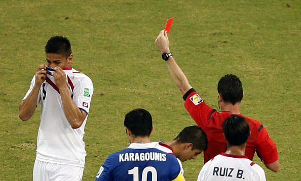 Costa Rica defender Oscar Duarte (L) is sent off by Australian referee Benjamin Williams during their round of 16 match against Greece in Recife during the 2014 FIFA World Cup on June 29, 2014. Photo: Getty Images
