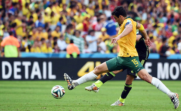 Australia's midfielder Mile Jedinak kikcs the ball during a Group B football match between Australia and Spain at the Baixada Arena in Curitiba during the 2014 FIFA World Cup on June 23, 2014. Photo: Getty Images