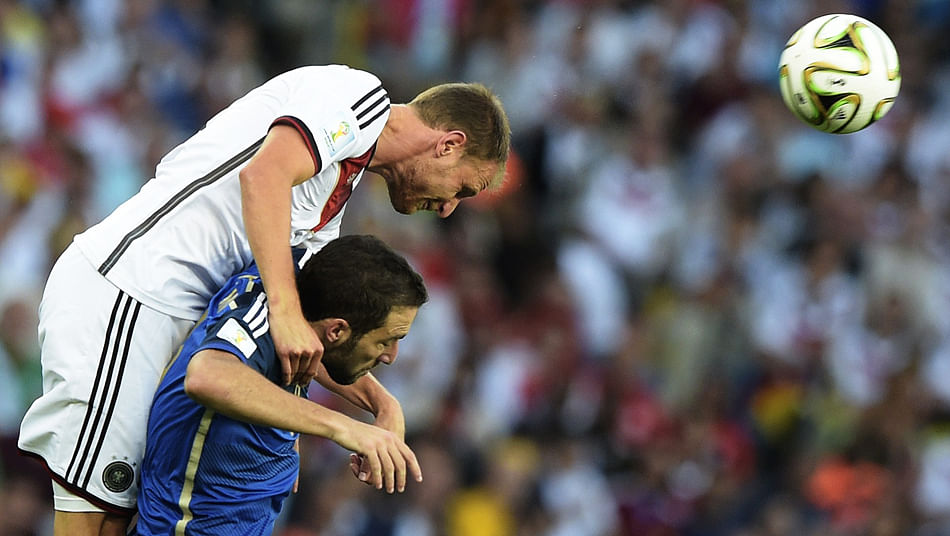 Germany's defender Benedikt Hoewedes (L) and Argentina's forward Gonzalo Higuain vie for the ball during the 2014 FIFA World Cup Brazil Final match between Germany and Argentina at Maracana on July 13, 2014 in Rio de Janeiro, Brazil. Photo: Getty Images