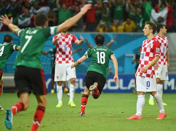 Luka Modric of Croatia and Hector Herrera of Mexico compete for the ball during the 2014 FIFA World Cup Brazil Group A match between Croatia and Mexico at Arena Pernambuco on June 23, 2014 in Recife, Brazil. Photo: Getty Images