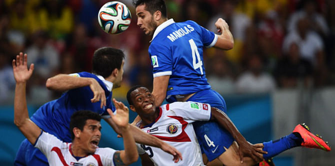 Greece's defender Koastas Manolas (R) heads the ball during a Round of 16 football match between Costa Rica and Greece at Pernambuco Arena in Recife during the 2014 FIFA World Cup on June 29, 2014. Photo: Getty Images
