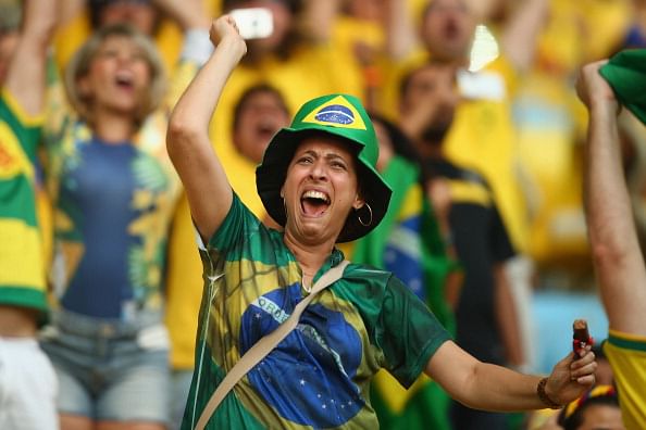 Brazil fans show their emotions as they watch the Brazil and Chile penalty shootout on the big screen ahead of the 2014 FIFA World Cup Brazil. Photo: Getty Images