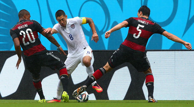 Clint Dempsey of the United States is challenged by Jerome Boateng (L) and Mats Hummels of Germany during the 2014 FIFA World Cup Brazil group G match between the United States and Germany at Arena Pernambuco on June 26, 2014 in Recife, Brazil. Photo: Getty Images