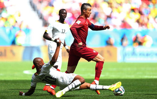 Andre Ayew of Ghana tackles Cristiano Ronaldo of Portugal during the 2014 FIFA World Cup Brazil Group G match between Portugal and Ghana at Estadio Nacional on June 26, 2014 in Brasilia, Brazil. Photo: Getty Images