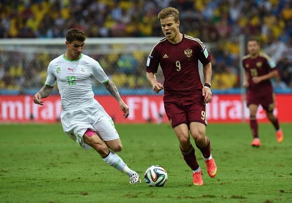 Russia's forward Alexander Kokorin (C) runs with the ball against Algeria's defender Carl Medjani during the Group H football match between Algeria and Russia at The Baixada Arena in Curitiba on June 26, 2014, during the 2014 FIFA World Cup. Photo: Getty Images