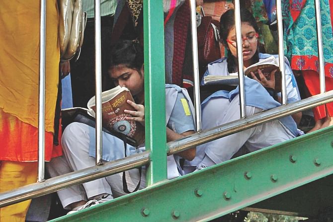 JSC examinees doing last-minutes panicky revision right on the stairs of a footbridge near the exam centre of Motijheel Govt Boys' High School & College around 7:30am yesterday. The examination would begin at 9:00am. Photo: Anisur Rahman