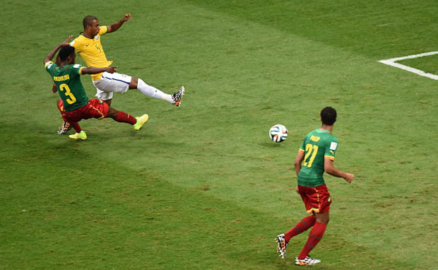 Brazil's midfielder Fernandinho (C-back) strikes the ball to score a goal as Cameroon's defender Nicolas Nkoulou defends during the Group A football match between Cameroon and Brazil at the Mane Garrincha National Stadium in Brasilia during the 2014 FIFA World Cup on June 23, 2014. Photo: Getty Images