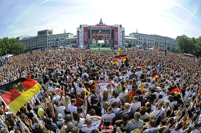 An overview taken with a fisheye lens shows German fans gather in front of a stage installed for a victory parade of Germany's football national team on July 15, 2014 at Berlin's landmark Brandenburg Gate to celebrate their FIFA World Cup title. Germany won their fourth World Cup title, after 1-0 win over Argentina on July 13, 2014 in Rio de Janeiro in the FIFA World Cup Brazil final game. Photo: Getty Images
