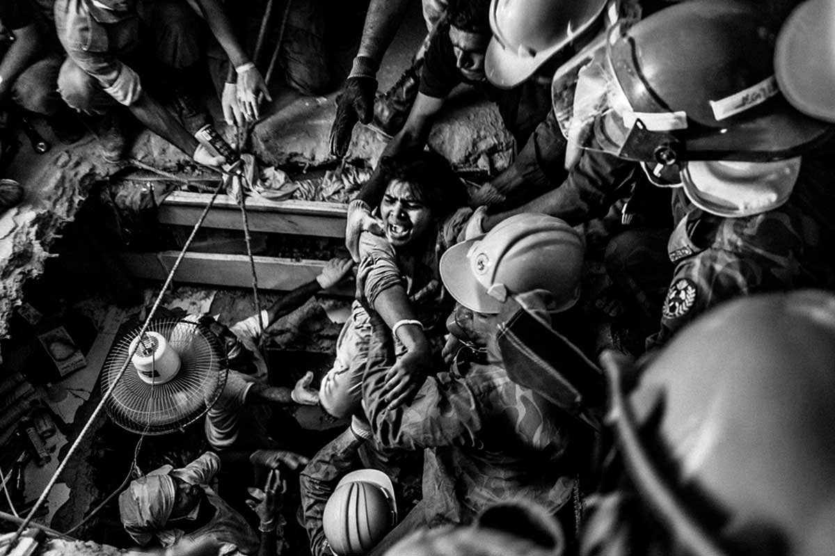 A rescued worker screams at the first sight of light after being trapped for 73 hours inside the rubble. Photo: Rahul Talukder