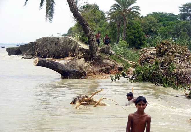Collapse of the embankment at Nizampur in Kalapara upazila under Patuakhali district on Friday flooded three villages inhabited by around 10 thousand people and affected nearby agricultural lands with saline water.  PHOTO: STAR