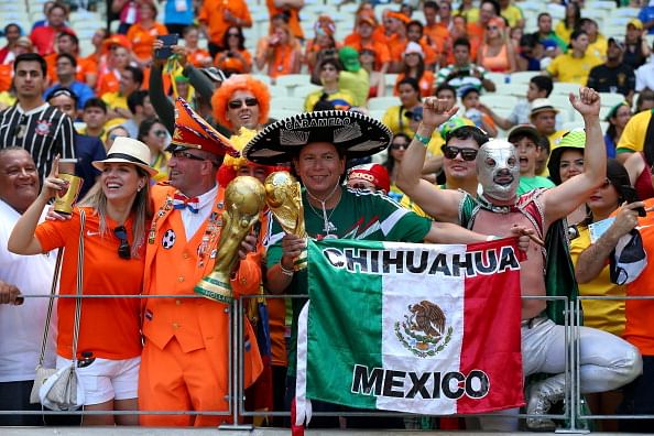 Mexico and Dutch fans soak up the atmosphere prior to the 2014 FIFA World Cup Brazil Round of 16 match between Netherlands and Mexico at Estadio Castelao on June 29, 2014 in Fortaleza, Brazil. Photo: Getty Images