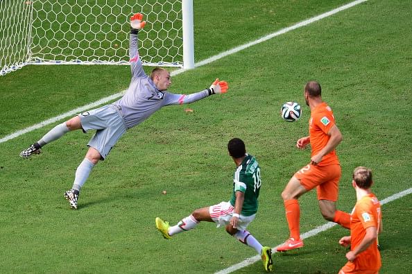 Netherlands' goalkeeper Jasper Cillessen (L) dives on a shot by Mexico's defender Andres Guardado (2ndL) during a Round of 16 football match between Netherlands and Mexico at Castelao Stadium in Fortaleza during the 2014 FIFA World Cup on June 29, 2014. Photo: Getty Images