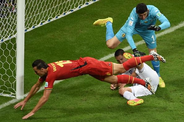 US forward and captain Clint Dempsey (C), Belgium's goalkeeper Thibaut Courtois (R) and Belgium's defender Daniel Van Buyten (L) vie for the ball during a Round of 16 football match between Belgium and USA at Fonte Nova Arena in Salvador during the 2014 FIFA World Cup on July 1, 2014. Photo: Getty Images