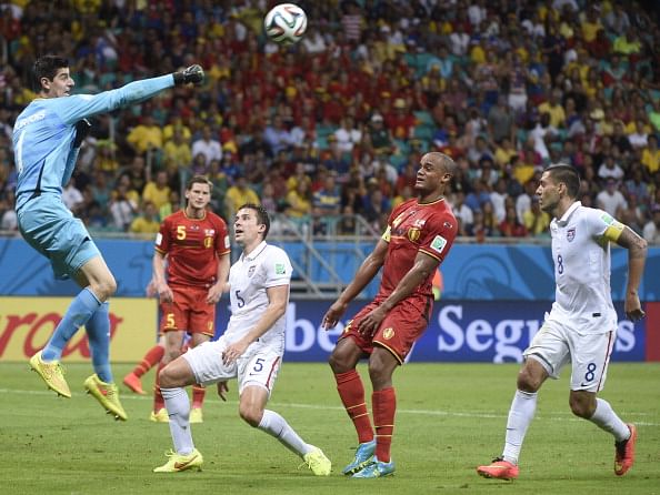 Belgium's goalkeeper Thibaut Courtois (L) punches the ball in front of Belgium's defender and captain Vincent Kompany (2R) during a Round of 16 football match between Belgium and USA at Fonte Nova Arena in Salvador during the 2014 FIFA World Cup on July 1, 2014. Photo: Getty Images)