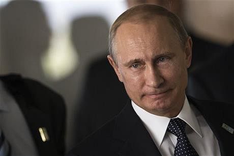 This, July 16, 2014, AP file photo shows Russia's President Vladimir Putin as he arrives for an official group photo during the BRICS summit at the Itamaraty palace, in Brasilia, Brazil. Months after Russia annexed Crimea and stepped up support for separatists in eastern Ukraine, Europe and the U.S. are still searching for an effective way to persuade Putin to change course. 