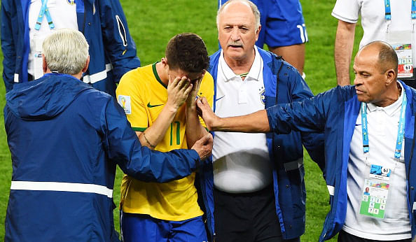 Brazil Head coach Luiz Felipe Scolari and staff console Oscar after a 7-1 defeat to Germany during their FIFA World Cup semi-final match on July 8, 2014 in Belo Horizonte, Brazil. Brazil. Photo: Getty Images