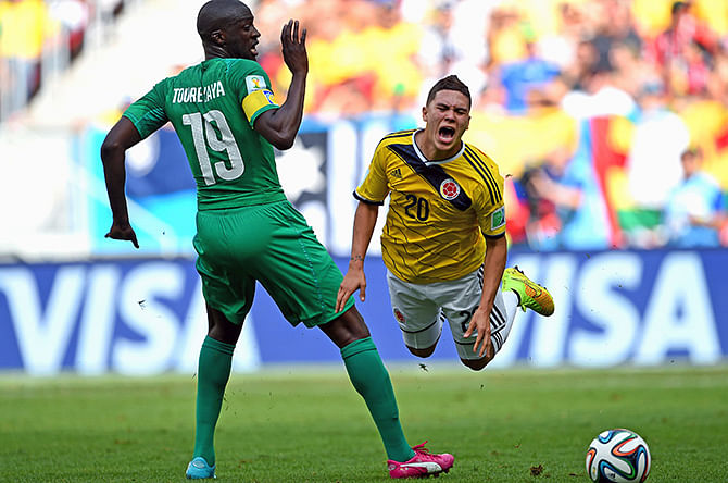 Juan Fernando Quintero of Colombia is brought down by Yaya Toure of the Ivory Coast during the 2014 FIFA World Cup Brazil Group C match between Colombia and Cote D'Ivoire at Estadio Nacional on June 19, 2014 in Brasilia, Brazil. Photo: Getty Images